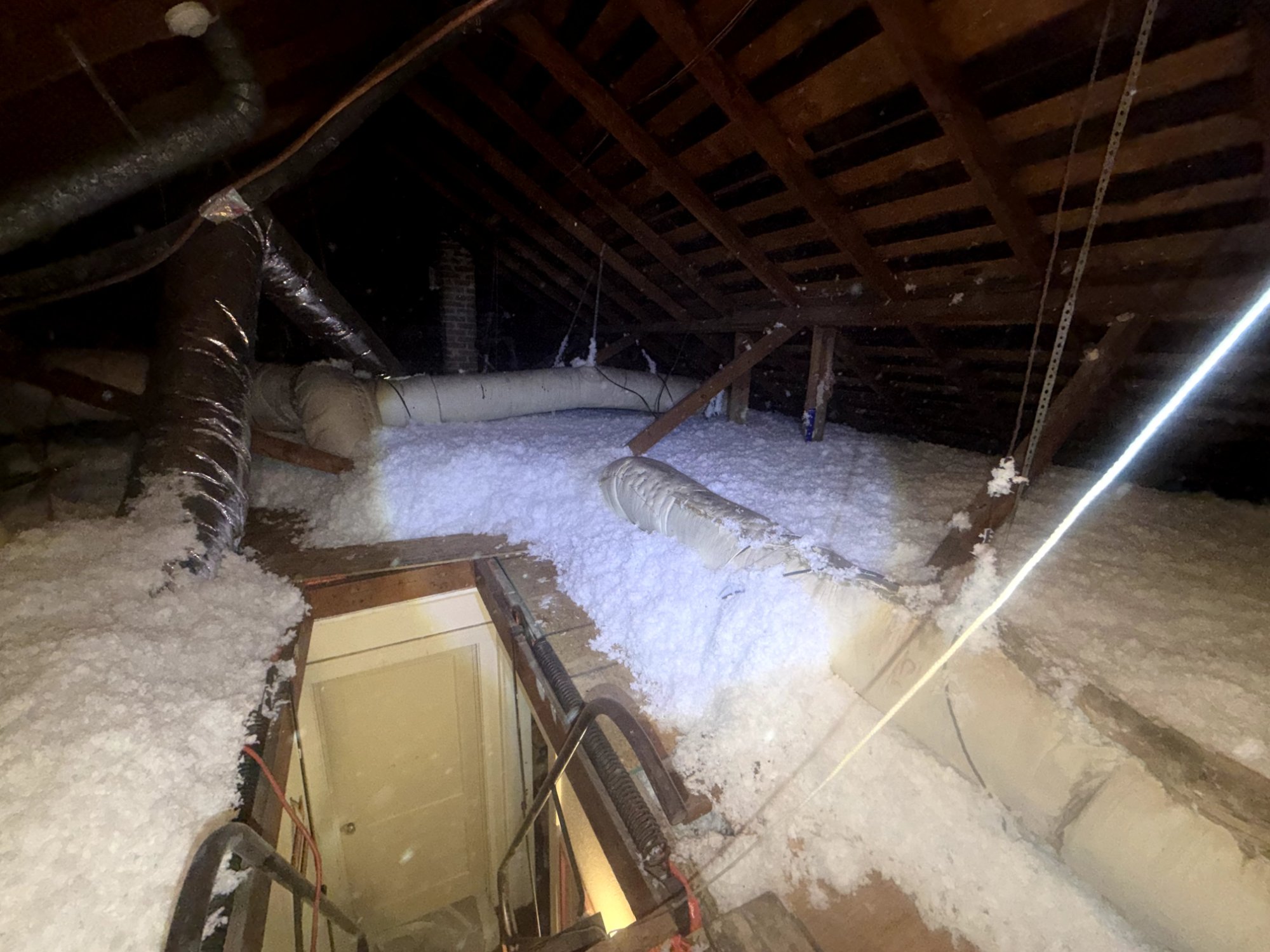 Blown-in insulation in an attic with hatch